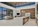 Spacious kitchen boasts a marble island, stainless steel appliances, and a cozy dining area with bright light at 49 Crested Cloud Way, Las Vegas, NV 89135