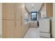 This laundry room has plenty of storage and counter space at 49 Crested Cloud Way, Las Vegas, NV 89135