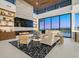 Bright living room with fireplace, custom shelving, wood ceilings, and expansive backyard views at 49 Crested Cloud Way, Las Vegas, NV 89135