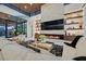 Open concept living room with fireplace, modern decor, wood ceilings, and floor-to-ceiling windows at 49 Crested Cloud Way, Las Vegas, NV 89135