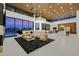 Expansive living space with modern decor, wood ceilings, bar, and views of the city at 49 Crested Cloud Way, Las Vegas, NV 89135