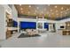 Spacious open-concept area with modern decor, bar, kitchen, dining area, and scenic backyard views at 49 Crested Cloud Way, Las Vegas, NV 89135