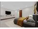 Contemporary bedroom with sleek built-ins, TV, and barn door to the bathroom at 49 Crested Cloud Way, Las Vegas, NV 89135
