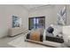This main bedroom boasts a sliding glass door to the backyard, and is tastefully decorated with modern artwork at 49 Crested Cloud Way, Las Vegas, NV 89135