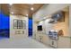 An outdoor kitchen with modern appliances, fire feature and stainless steel fixtures at 49 Crested Cloud Way, Las Vegas, NV 89135