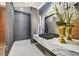 Modern powder room featuring a floating marble countertop, dark textured wallpaper, and elegant fixtures at 49 Crested Cloud Way, Las Vegas, NV 89135