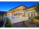 Modern home featuring an outdoor kitchen, infinity pool, and stunning desert landscaping at 49 Crested Cloud Way, Las Vegas, NV 89135
