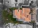 Stunning aerial view of a single Gathering home featuring a terracotta tile roof, landscaping and a clean white car in the driveway at 5205 Sandy Cactus Ln, Las Vegas, NV 89149