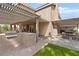 Outdoor kitchen and shaded patio make this backyard ideal for entertaining at 5205 Sandy Cactus Ln, Las Vegas, NV 89149