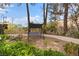 Backyard sitting area with privacy landscaping, a charming swing, and gravel at 5205 Sandy Cactus Ln, Las Vegas, NV 89149