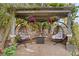 Cozy patio area featuring comfortable seating, hanging flower baskets and a warm fire pit for relaxed outdoor living at 5205 Sandy Cactus Ln, Las Vegas, NV 89149