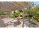 Backyard featuring a stone fountain, landscaping, and pergola at 5205 Sandy Cactus Ln, Las Vegas, NV 89149