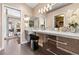 Bathroom featuring dual sinks, stylish cabinetry and mirrors, and an adjacent water closet at 5205 Sandy Cactus Ln, Las Vegas, NV 89149