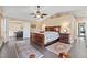 Spacious bedroom with tray ceilings, a ceiling fan, and an ensuite bathroom offering extra privacy at 5205 Sandy Cactus Ln, Las Vegas, NV 89149