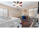 Bedroom with ceiling fan, closet, desk, and a decorative rug at 5205 Sandy Cactus Ln, Las Vegas, NV 89149