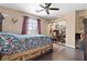 Cozy bedroom featuring hardwood floors, a ceiling fan and natural lighting at 5205 Sandy Cactus Ln, Las Vegas, NV 89149