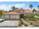 Charming two-story home with a terracotta roof, landscaped front yard, and a spacious three-car garage at 5205 Sandy Cactus Ln, Las Vegas, NV 89149