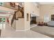 Spacious foyer showcasing an elegant staircase, neutral walls, and views of the dining room and living room at 5205 Sandy Cactus Ln, Las Vegas, NV 89149