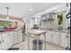 Modern kitchen features white cabinetry, stainless steel appliances, tiled backsplash and convenient central island with butcher block at 5205 Sandy Cactus Ln, Las Vegas, NV 89149