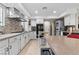 Updated kitchen with stainless steel appliances, granite counters, and white cabinetry at 5205 Sandy Cactus Ln, Las Vegas, NV 89149