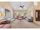 Stylish living room features high ceilings, natural light, neutral decor, comfortable seating and creates a welcoming atmosphere at 5205 Sandy Cactus Ln, Las Vegas, NV 89149