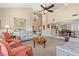Open living space with neutral walls, large windows, elegant chandelier, seamlessly connecting living, dining, and entertaining areas at 5205 Sandy Cactus Ln, Las Vegas, NV 89149