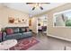 Comfortable living room with a dark leather sofa, hardwood floors, and an adjacent bedroom at 5205 Sandy Cactus Ln, Las Vegas, NV 89149