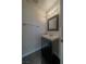 Updated powder room with modern vanity, fixtures, and decorative mirror at 5256 Harvest Breeze Rd, Las Vegas, NV 89118