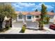 Charming townhome featuring a two-car garage, red-tile roof and manicured landscaping at 5256 Harvest Breeze Rd, Las Vegas, NV 89118