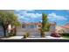 Charming townhome featuring a two-car garage, red-tile roof and manicured landscaping at 5256 Harvest Breeze Rd, Las Vegas, NV 89118