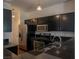Modern kitchen featuring stainless steel appliances, dark cabinetry, and granite counters at 5256 Harvest Breeze Rd, Las Vegas, NV 89118