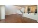 Spacious living room with hardwood floors, staircase, and kitchen bar, great for entertaining at 5256 Harvest Breeze Rd, Las Vegas, NV 89118