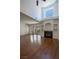 Living room with fireplace, hardwood floors and tall windows at 5256 Harvest Breeze Rd, Las Vegas, NV 89118