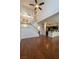 Bright living room featuring an open floor plan, hardwood floors, and a staircase at 5256 Harvest Breeze Rd, Las Vegas, NV 89118