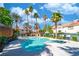 A sparkling community pool with ample seating, surrounded by lush landscaping, and beautiful blue skies at 5256 Harvest Breeze Rd, Las Vegas, NV 89118