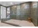 Walk-in shower featuring rain shower head, glass enclosure, and a built-in bench at 532 Crown Mesa Ave, Las Vegas, NV 89138