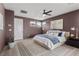 Well-lit bedroom featuring mountain views, neutral decor, and a ceiling fan at 532 Crown Mesa Ave, Las Vegas, NV 89138