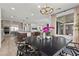 Open concept home with a dining area that features modern chandelier lighting and seamless flow into the kitchen and living area at 532 Crown Mesa Ave, Las Vegas, NV 89138