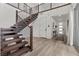 Elegant entryway with a wooden staircase and modern decor, showcasing a bright and welcoming atmosphere at 532 Crown Mesa Ave, Las Vegas, NV 89138