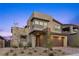 Contemporary home with a stone facade, well-manicured landscaping, and a welcoming entrance at 532 Crown Mesa Ave, Las Vegas, NV 89138