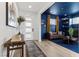 Welcoming foyer with modern decor, stylish console table, and doorway leading to a room with blue walls at 532 Crown Mesa Ave, Las Vegas, NV 89138