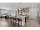Open-concept kitchen with a large island, bar stool seating, and modern pendant lighting fixtures at 532 Crown Mesa Ave, Las Vegas, NV 89138