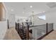 Second-story landing with contemporary chandelier, wood floors, and natural light at 532 Crown Mesa Ave, Las Vegas, NV 89138