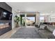 Contemporary living room with fireplace, stylish gray sofa, and views of the pool through sliding glass doors at 532 Crown Mesa Ave, Las Vegas, NV 89138