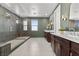 Luxurious main bathroom with a glass-enclosed shower, dual vanities, and elegant fixtures at 532 Crown Mesa Ave, Las Vegas, NV 89138