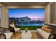 Cozy covered patio with stylish seating, overlooking a well-maintained backyard with a sparkling pool at 532 Crown Mesa Ave, Las Vegas, NV 89138