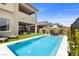 Inviting backyard featuring a sparkling in-ground pool, lush landscaping, and a relaxing lounge area at 532 Crown Mesa Ave, Las Vegas, NV 89138