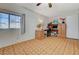 This bedroom features wood-look vinyl flooring, a window for natural light and a built in desk with storage at 5607 Tunis Ave, Las Vegas, NV 89122