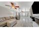 Comfortable living room features tile floors, a ceiling fan, and a stylish sectional sofa at 5607 Tunis Ave, Las Vegas, NV 89122