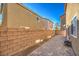 Private backyard featuring a paved patio area, brick wall, and low-maintenance landscaping at 6217 Red Jamboree Ct, Las Vegas, NV 89130